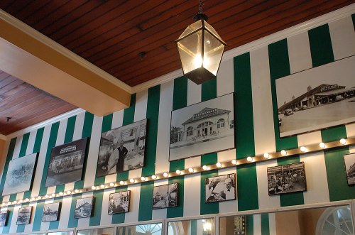 The inside of the Cafe Du Monde with photos of the historic cafe.